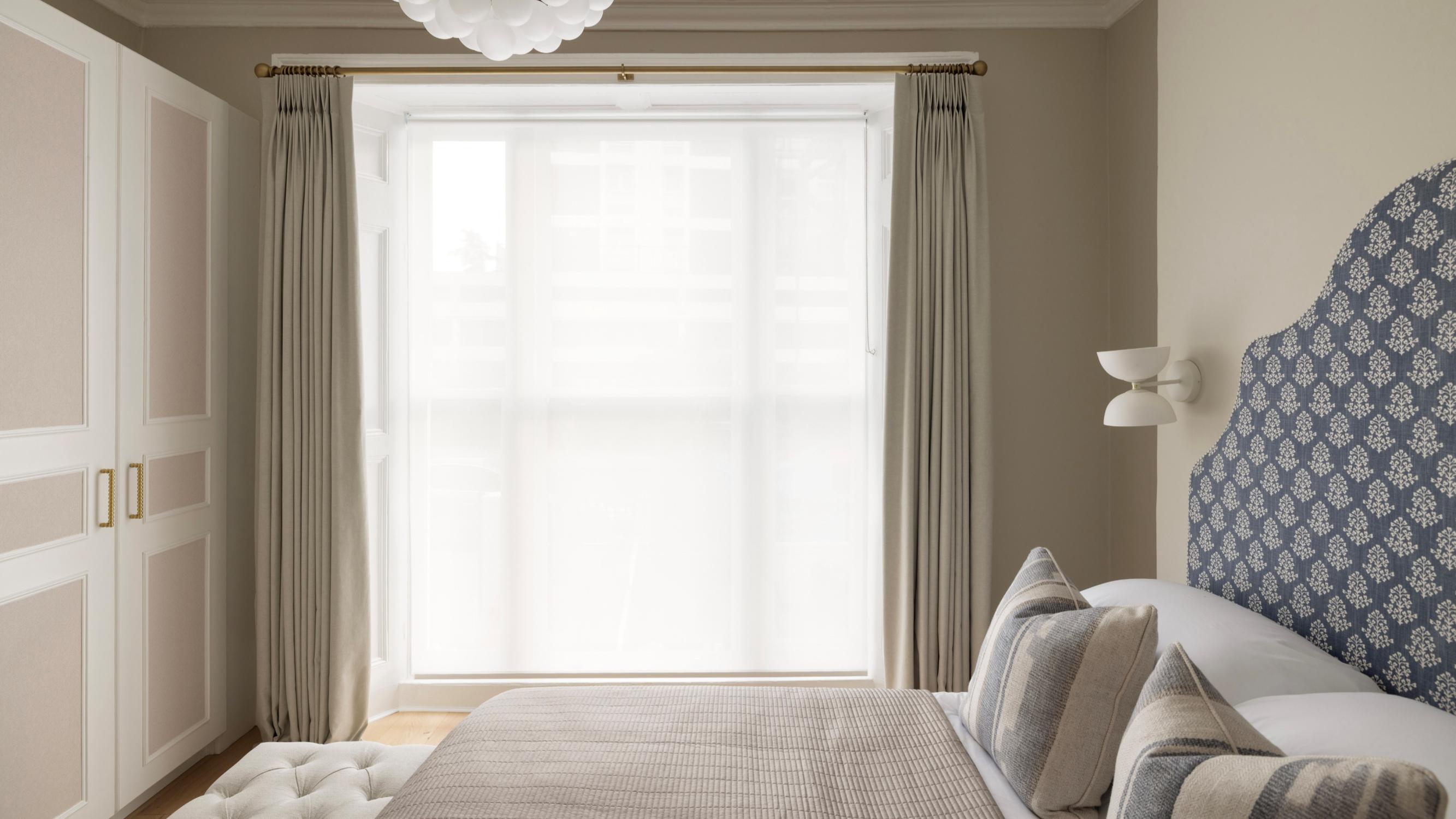 A renovated period bedroom, hand-blocked headboard