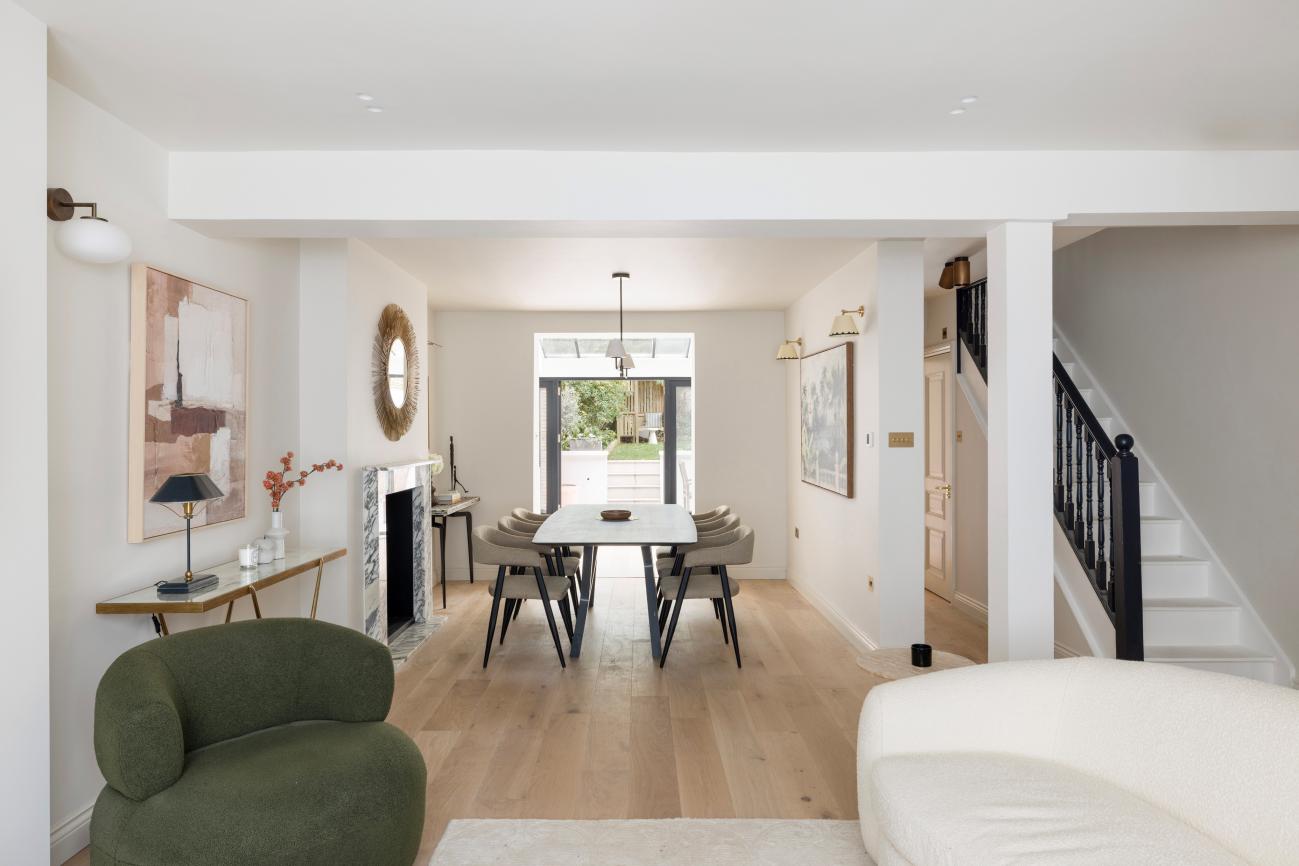 A renovated W11 reception with chandelier and herringbone floor