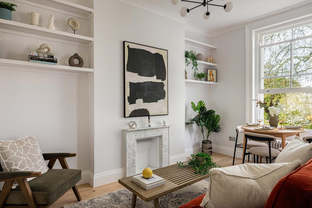 A reconfigured W11 reception centred on a marble fireplace